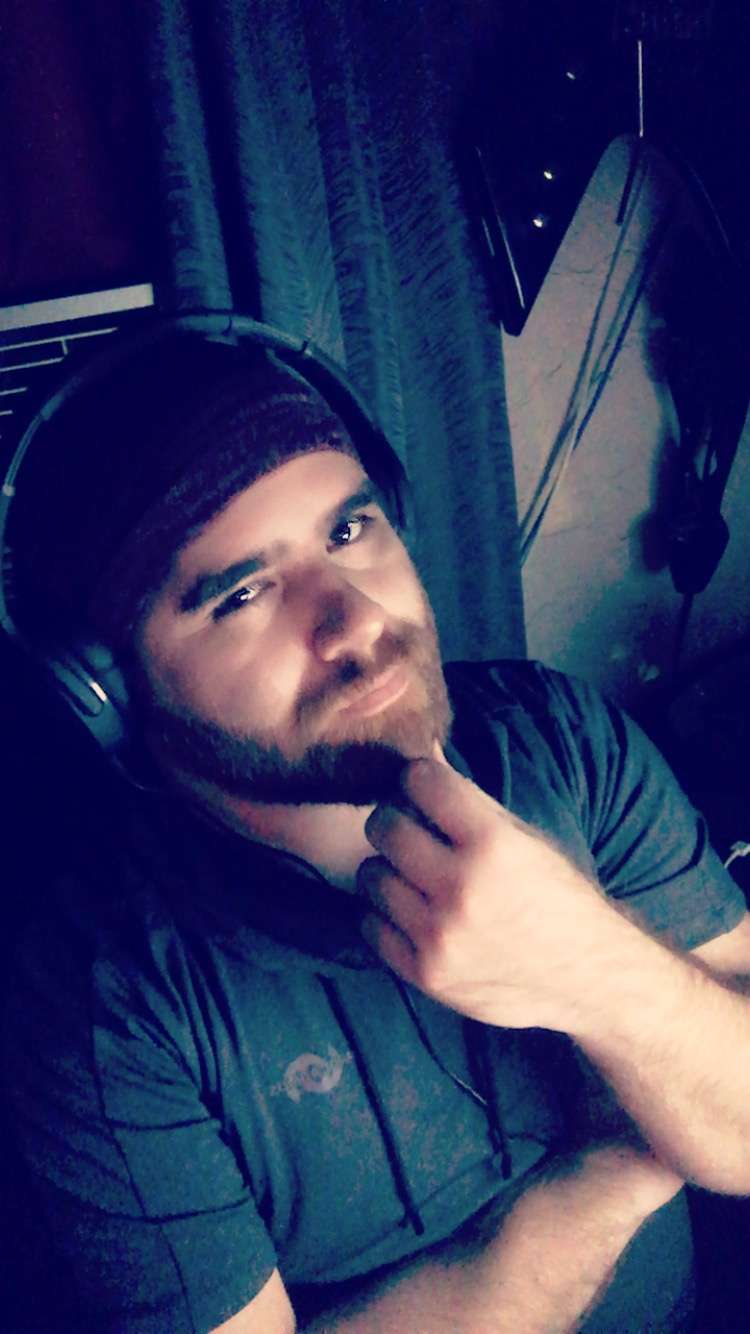 Joshua with Skullcandy Crushers posing at camera